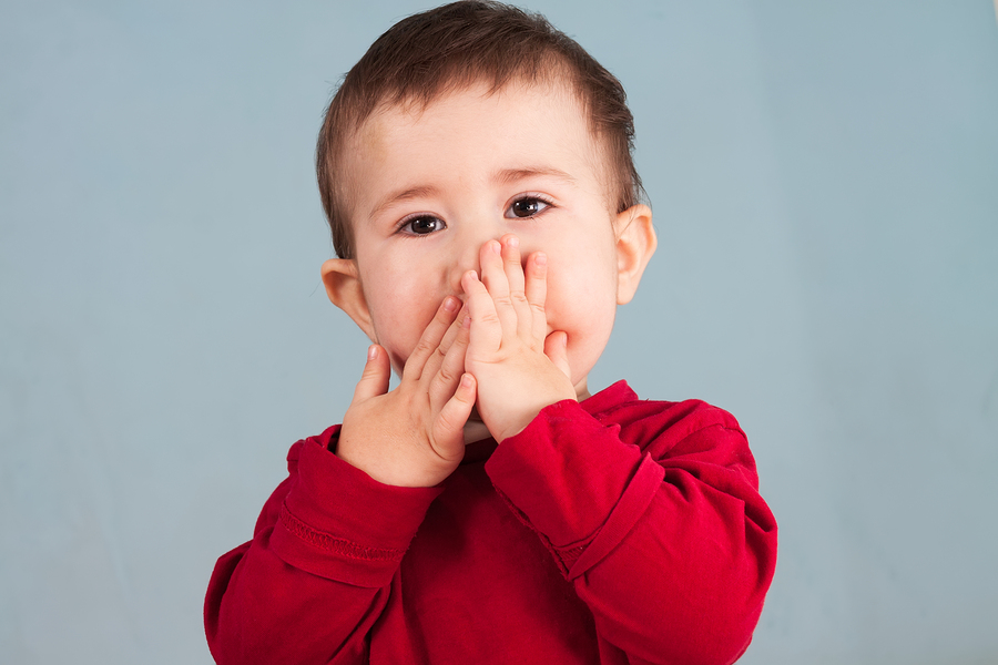 bigstock Child Covers Mouth With Hands 55173149